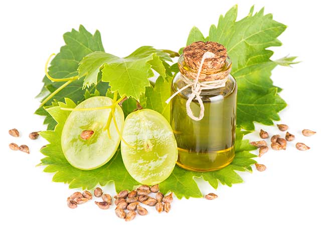 Aceite De Semilla De Uva En Una Botella De Vidrio Cerca De Uvas Frescas.